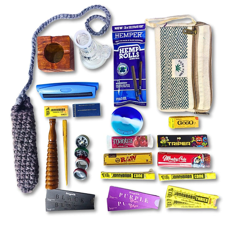 Collection of smoking bong, chillum, cigarette roller, grinder, rolling silione bowl and rolling papers on a white background