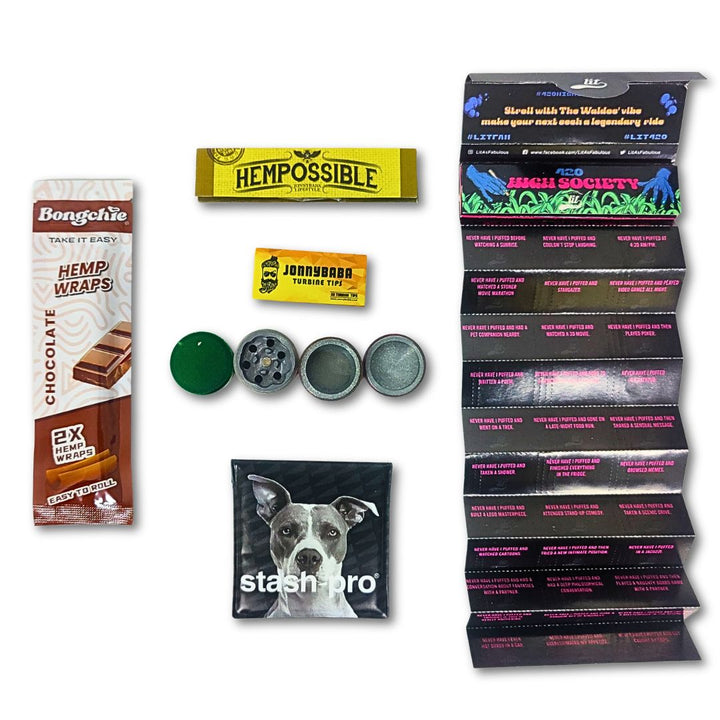 Collection of bongchie blunt, metal grinder, stash pro pocket ashtray, rolling papers on a white background.