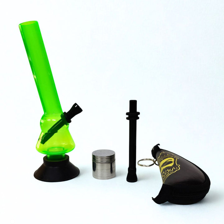 Green Acrylic bong with metal shooter, crushing pouch and grinder on a white background