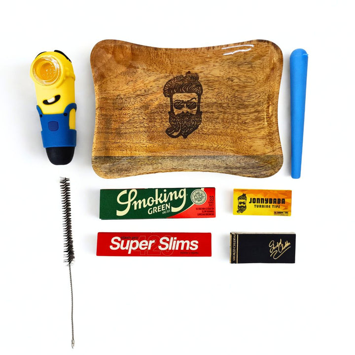 Minion smoking pipe with wooden rolling tray, rolling papers, roachbooks, cleaning brush and doobtube on white background