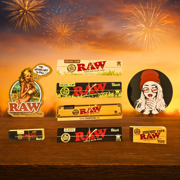 Raw rolling paper, tips and stickers with fireworks in the background