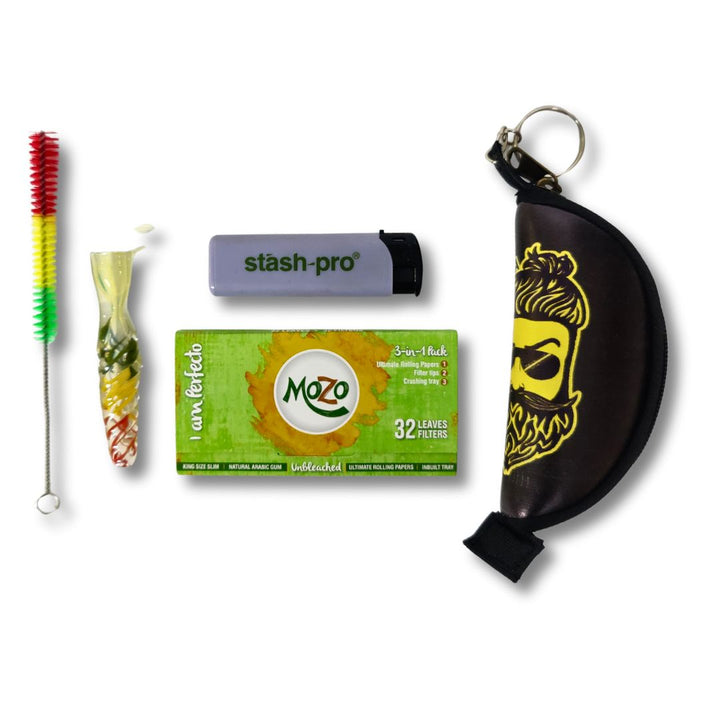 Rasta one hitter pipe, mozo brown with tips, cleaning brush, crushing pouch and a lighter on a white background.