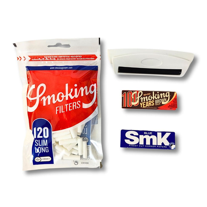 Smoking slim and long  filters with 79 mm cigarette rolling machine and cigarette papers on white background