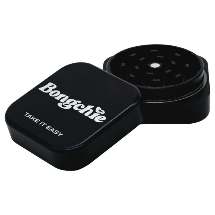 Black herb grinder with 'Bongchie' branding on a white background
