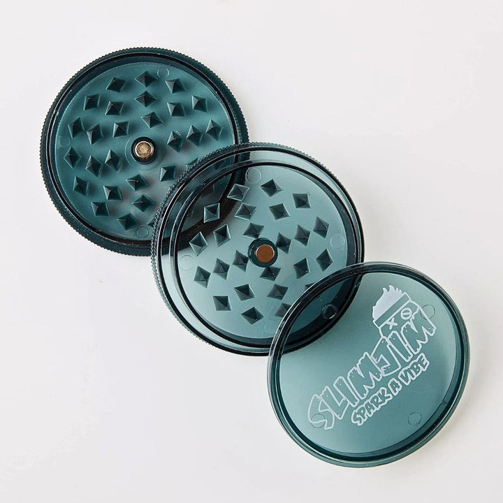 Three part plastic grinder with diamond-patterned top and brand logo on a white background