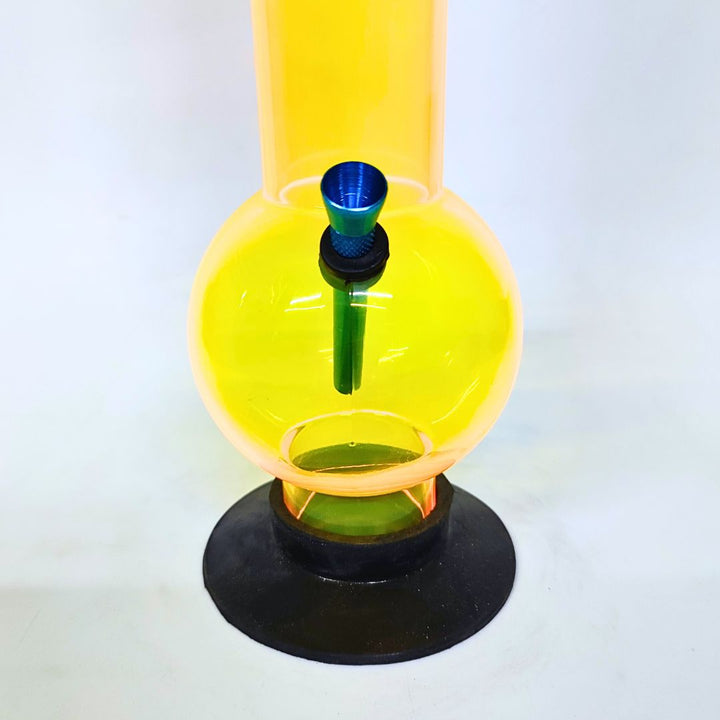 Yellow glass bong with black base on a white background