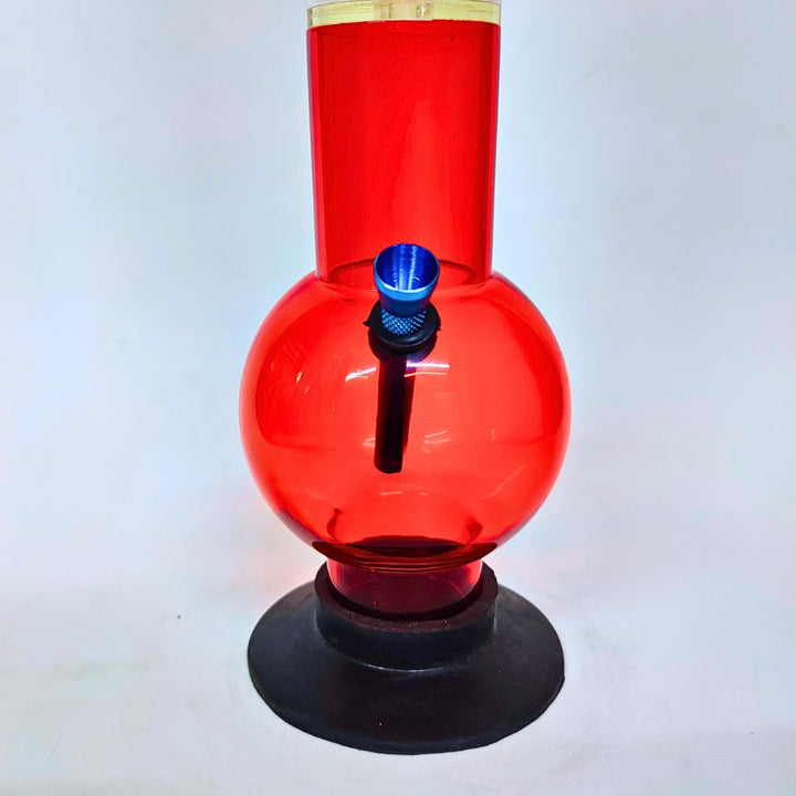 Red plastic water bong with black base on a white background