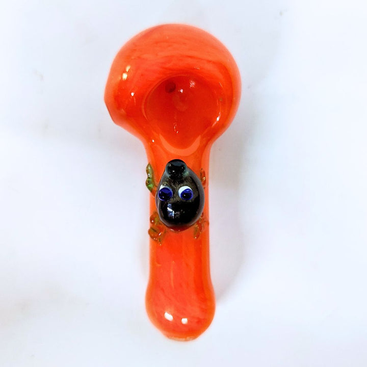 Glass smoking pipe with a red-orange handle and black bowl on a white background