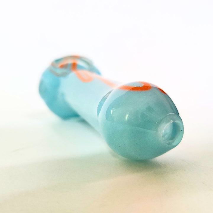Turquoise glass pipe with orange accents on a white background