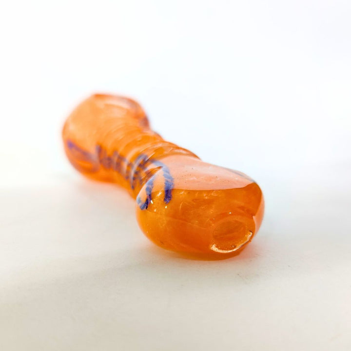 Orange glass pipe with blue accents on a white background