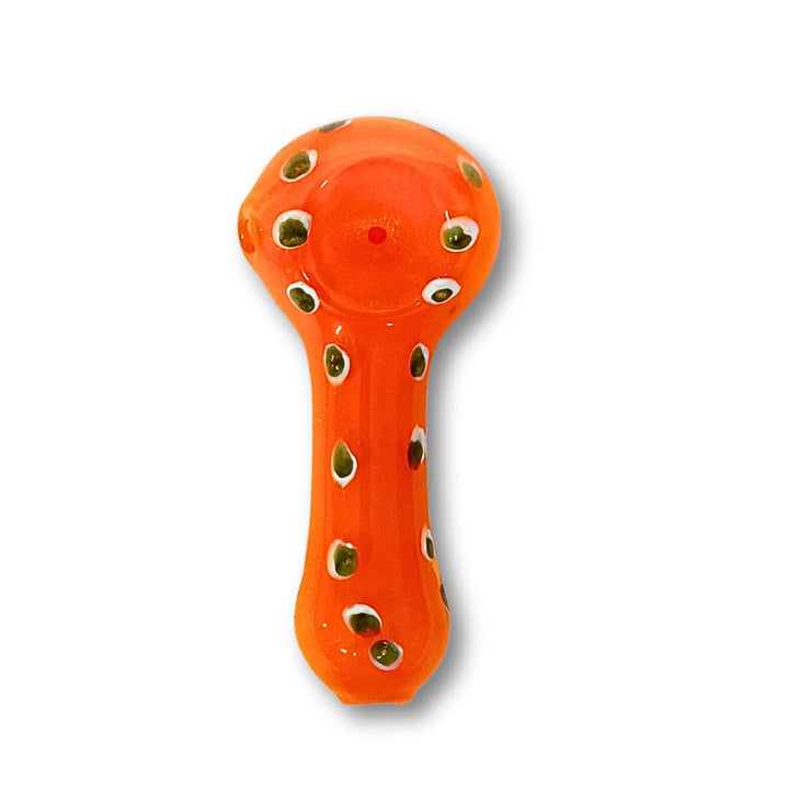 Orange glass smoking pipe with decorative holes on a white background