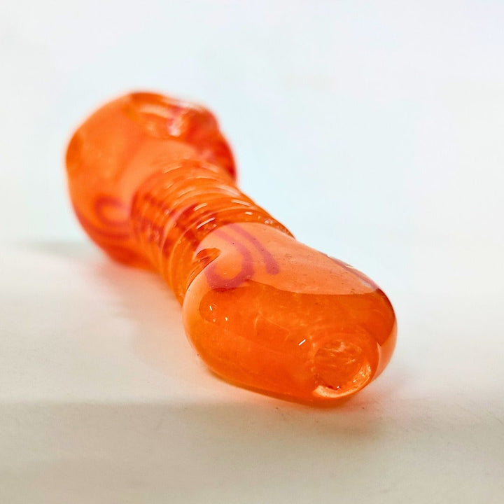 Close-up of an orange plastic object on a white background