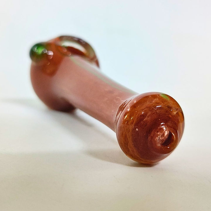 Glass pipe with a marbled brown and green design on a white background