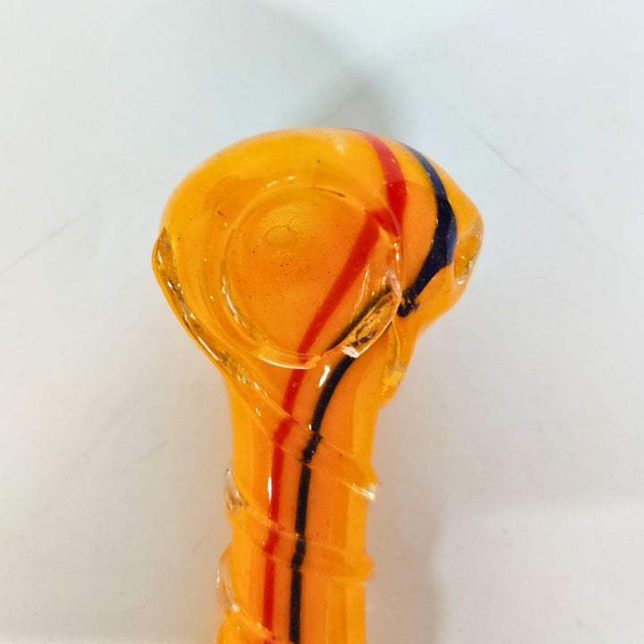 Glass pipe with orange and black design on a white background