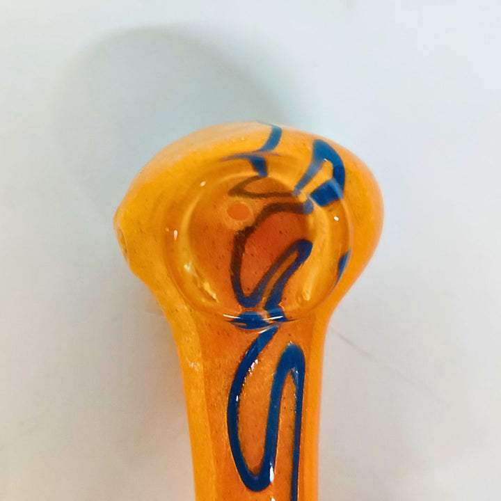 Orange glass pipe with blue swirl design on a white background