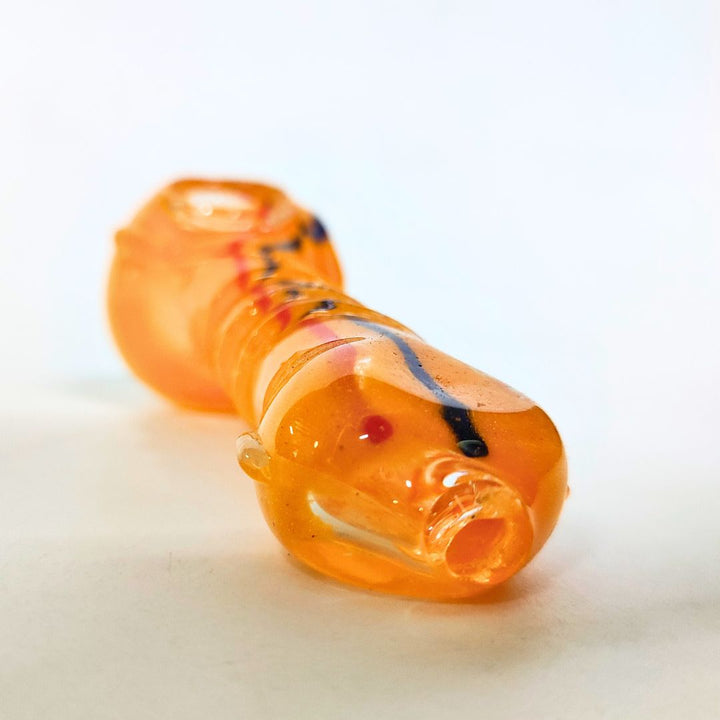 Orange glass pipe with black and red accents on a white background