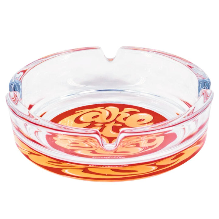 Glass ashtray with red and orange design on a white background