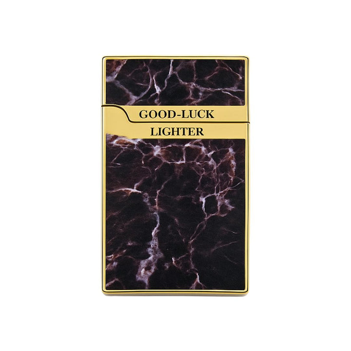 Good-luck lighter with gold trim and black marbled design on a white background