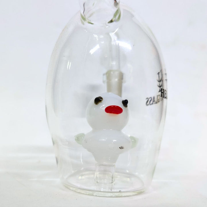 Glass bong with a small white duck figure inside on a white background