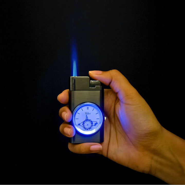 Hand holding a lighter with a clock design, igniting it against a dark background