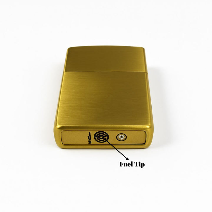 Gold lighter with fuel tip indicator on a white background