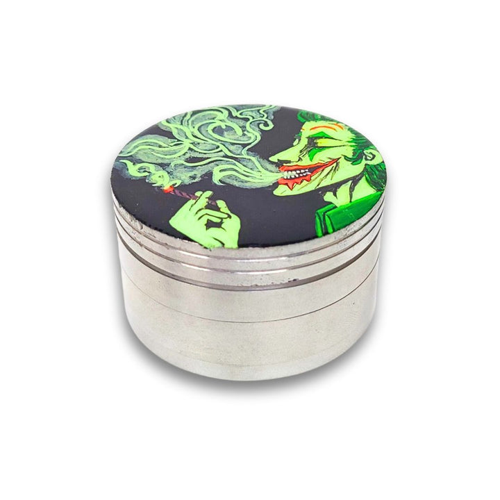 Metallic grinder with a colorful design on the lid against a white background