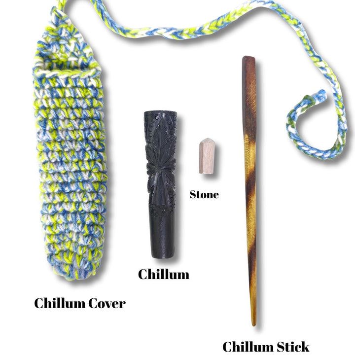 Chillum and accessories including a cover, stone, and stick on a white background