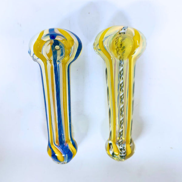 Two glass smoking pipes, one blue and yellow, the other clear with a pattern, on a white background.