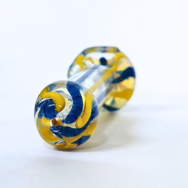 Glass pipe with blue and yellow swirl design on a white background