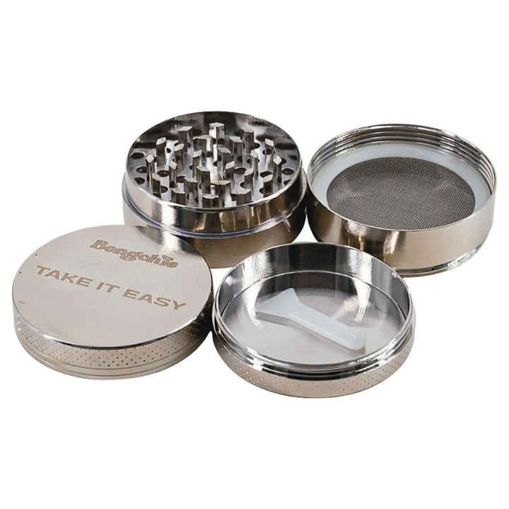Metal grinder with multiple compartments on a white background