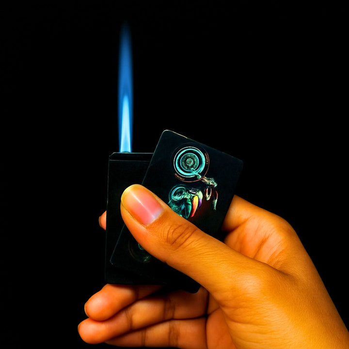 Hand holding a lighter with a colorful design against a black background