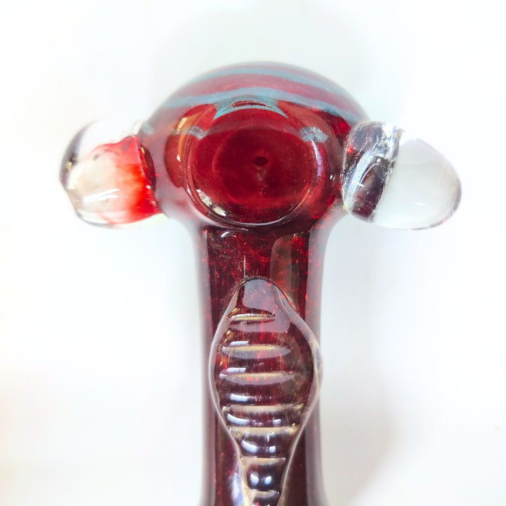 Glass smoking pipe with red interior on a white background