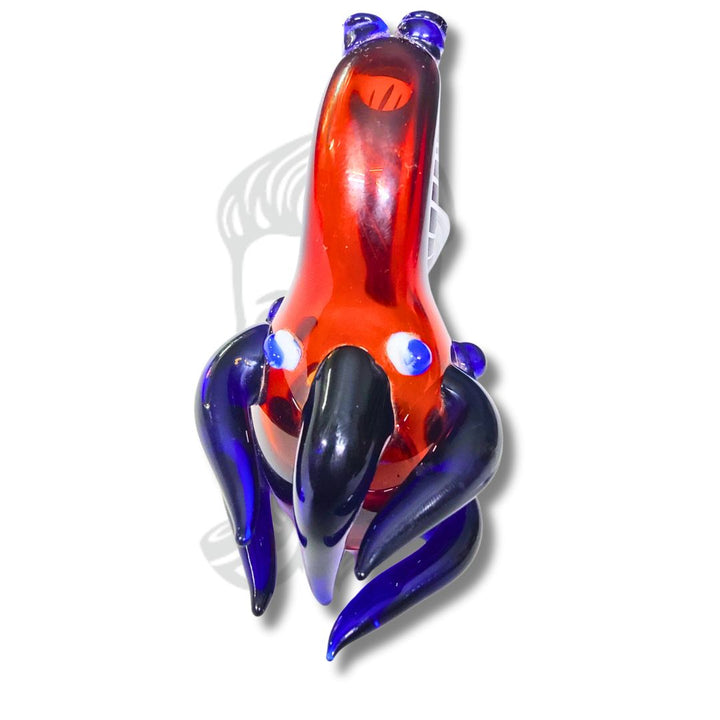 Colorful glass sculpture of a creature on a white background