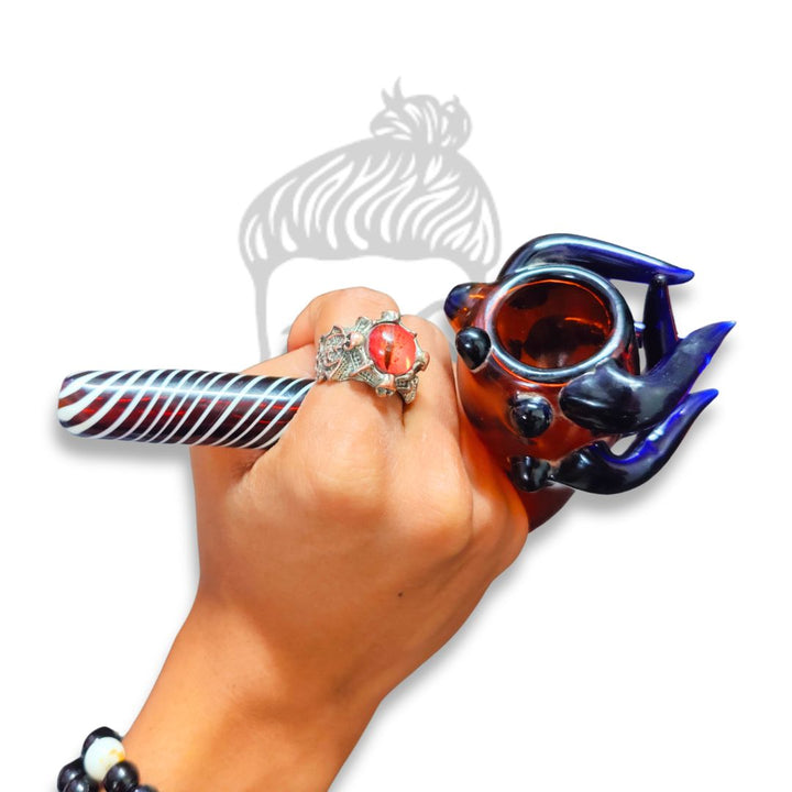Hand holding a colorful glass pipe with a white background