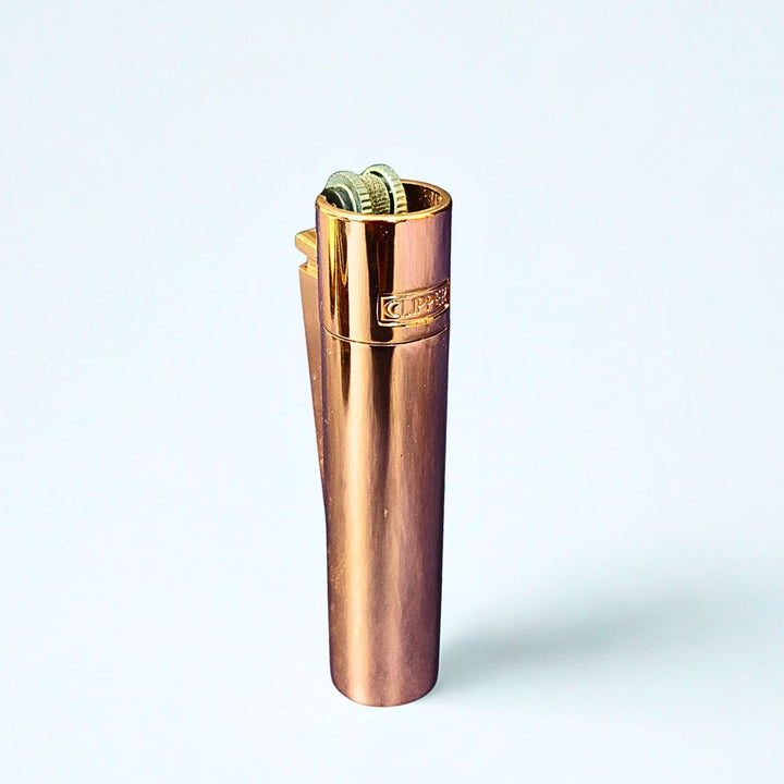 Clipper Rose gold metal lighter on a white background