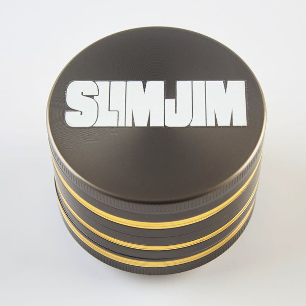 Black and gold four-layered grinder with 'SLIMJIM' branding on a white background