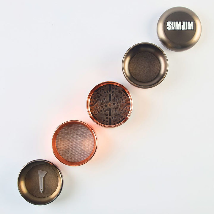Collection of metal grinders with different designs on a white background, featuring the Slim Jim brand.