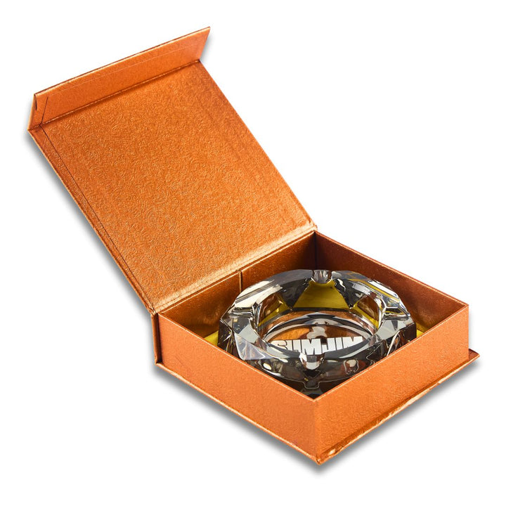 Crystal ashtray in an open orange box on a white background