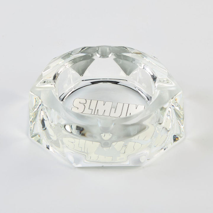 Clear diamond-shaped object with 'SLIMJIM' branding on a light gray background