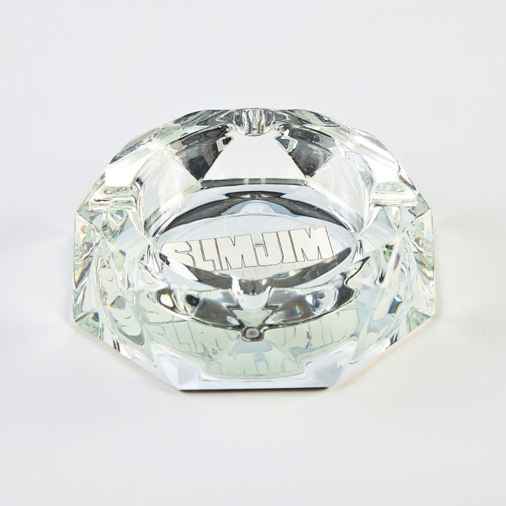 Clear diamond-shaped ashray with 'Slim Jim' branding on a light gray background