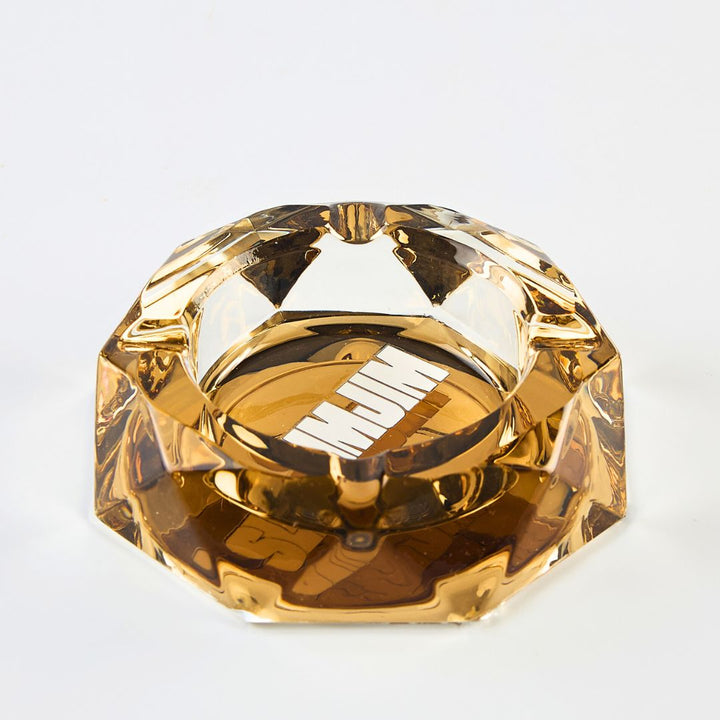 Gold-colored diamond-shaped object on a white background