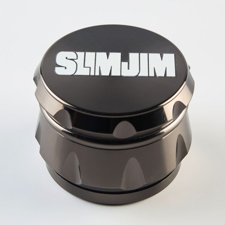 Black and bronze grinder with 'SLIMJIM' branding on a light gray background