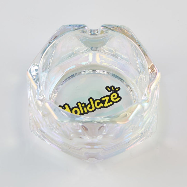 Clear glass ashtray with 'Holidaze' logo on a white background