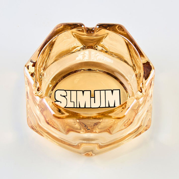 Gold-colored product with 'SLIMJIM' branding on a light gray background