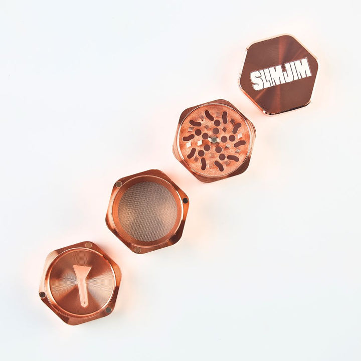 Copper-colored metal grinders with 'Slimjim' branding on a white background