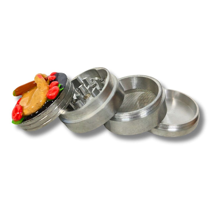 Metal grinder with compartments on a white background