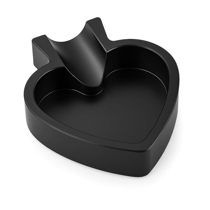 Black heart-shaped container with a handle on a white background