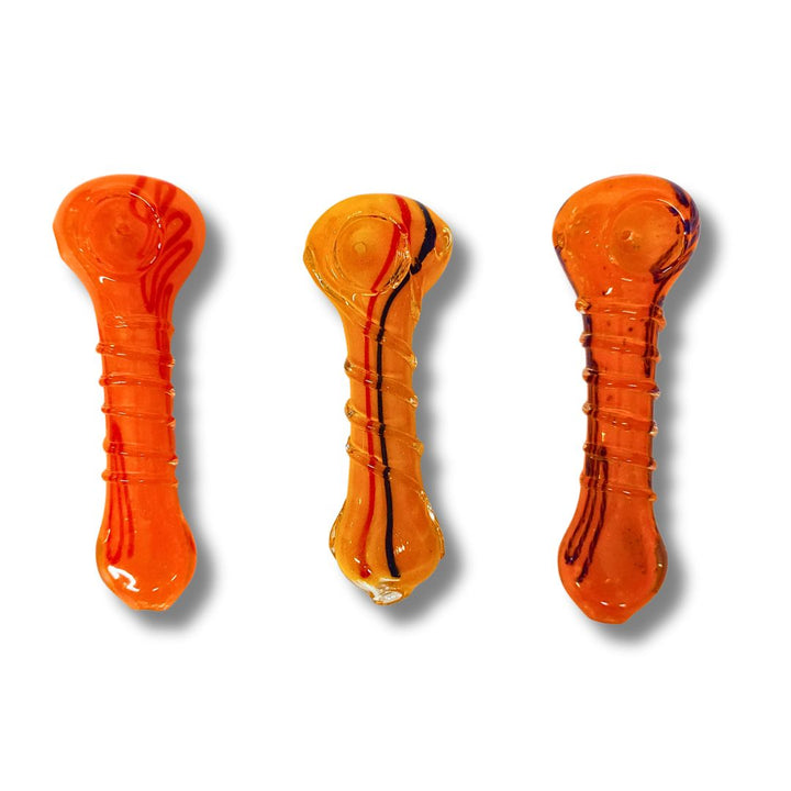 Three orange glass pipes on a white background