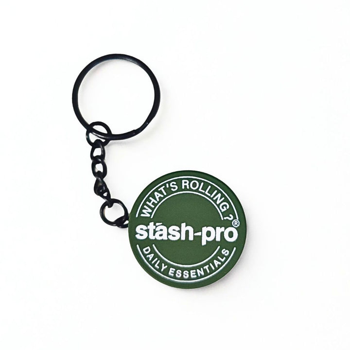Green keychain Grinder with 'stash-pro' branding on a white background