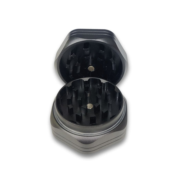 Black and silver herb grinder on a white background